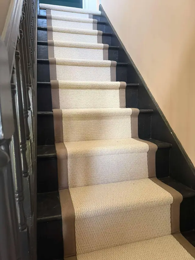 Cream runner against a dark staircase