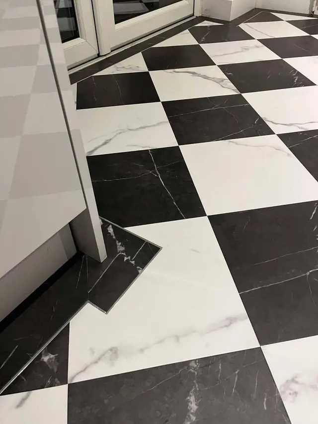 Black and white checkerboard LVT in a kitchen
