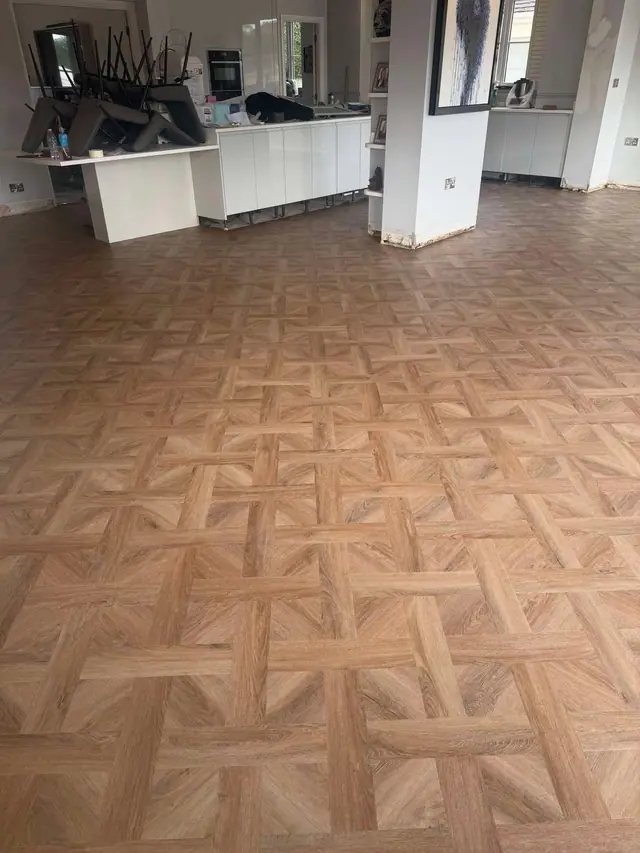 Decorative parquet-effect LVT across a kitchen