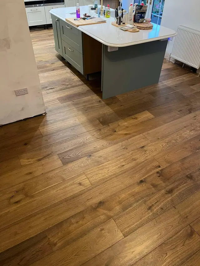 Natural wood flooring around a kitchen island