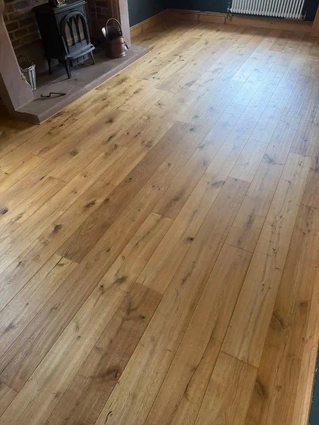 Real wood flooring beside a fireplace