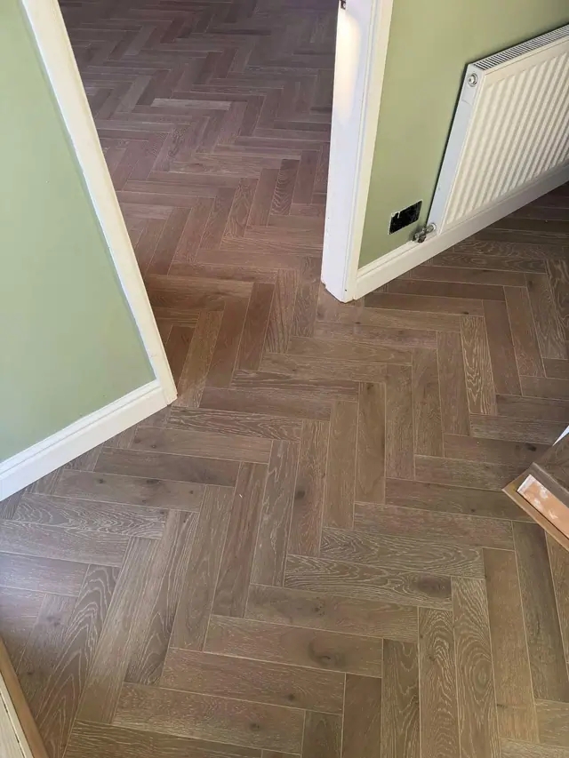 Real wood herringbone through a doorway