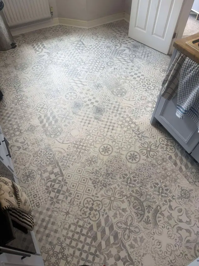 Pale patchwork-pattern vinyl in a kitchen