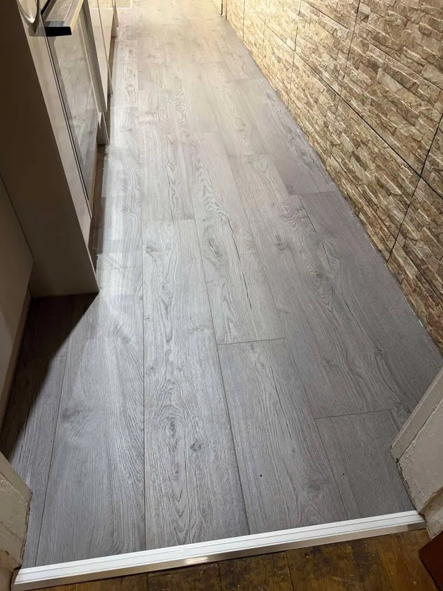 Grey wood-effect laminate in a galley kitchen